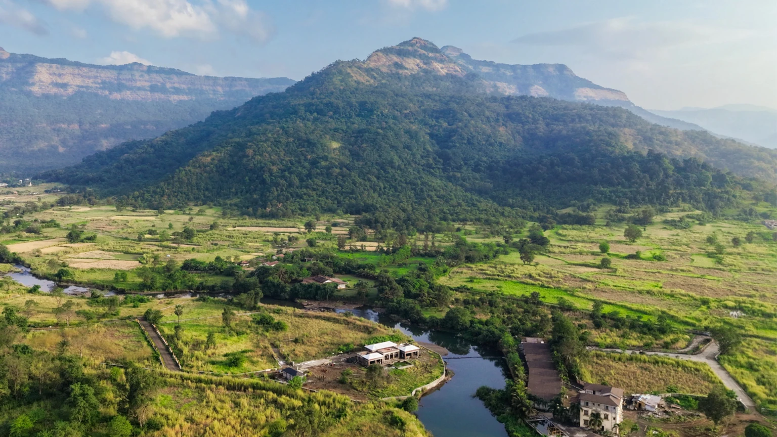 Agricultural plots in Karjat for sale surrounded by lush green farmland and hills